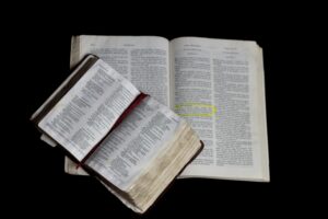 Holy Bibles on Plain Black Background